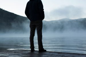 man standing at lake